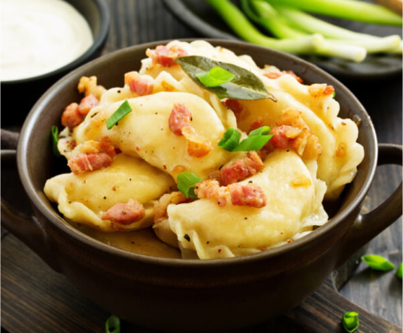 Dumplings with bacon and onion garnish